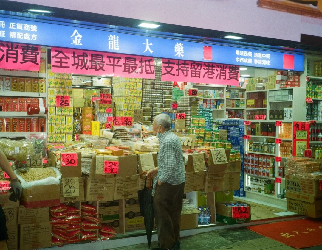 A man standing in front of a store filled with boxes